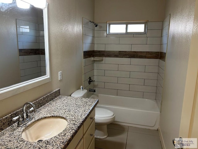 full bathroom featuring tile patterned flooring, vanity, toilet, and tiled shower / bath