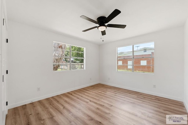 spare room with ceiling fan, plenty of natural light, and light hardwood / wood-style flooring