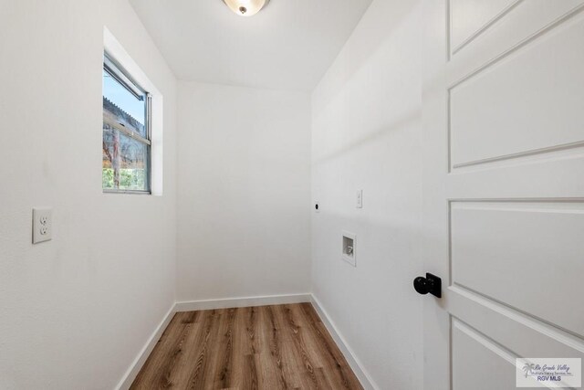 clothes washing area with hookup for an electric dryer, hardwood / wood-style floors, and hookup for a washing machine