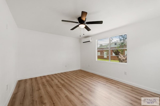 unfurnished room with a wall unit AC, ceiling fan, and light wood-type flooring