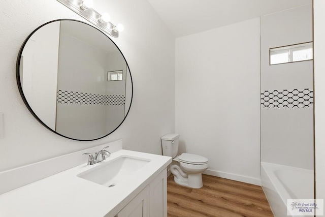 bathroom with hardwood / wood-style floors, vanity, and toilet