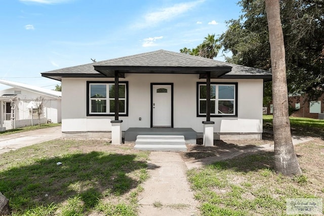 view of front facade with a porch and a front lawn