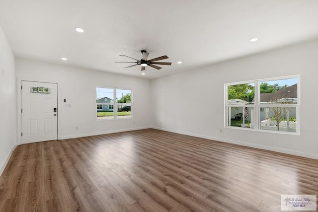 unfurnished living room with hardwood / wood-style floors and ceiling fan