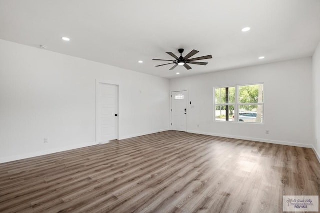 unfurnished room with ceiling fan and wood-type flooring