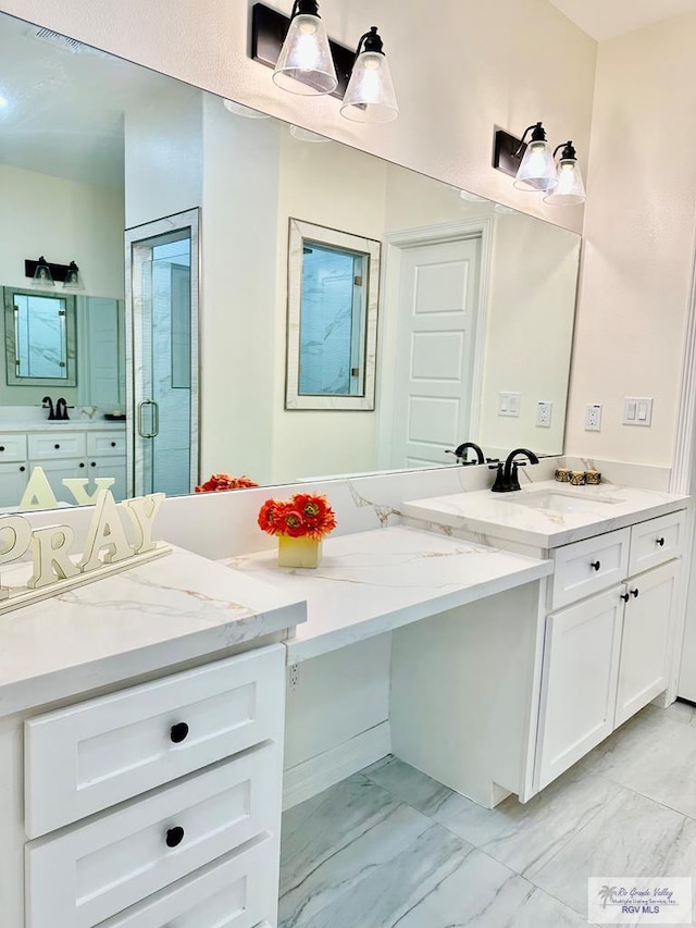 bathroom featuring vanity and a shower with door