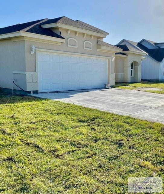 view of front of house with a garage and a front yard