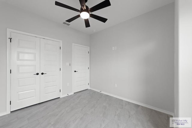 unfurnished bedroom with a closet and ceiling fan