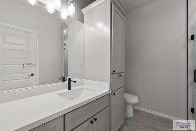 bathroom with vanity, toilet, and an enclosed shower