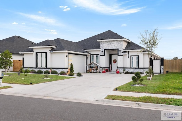 view of front of house featuring a front yard and a garage