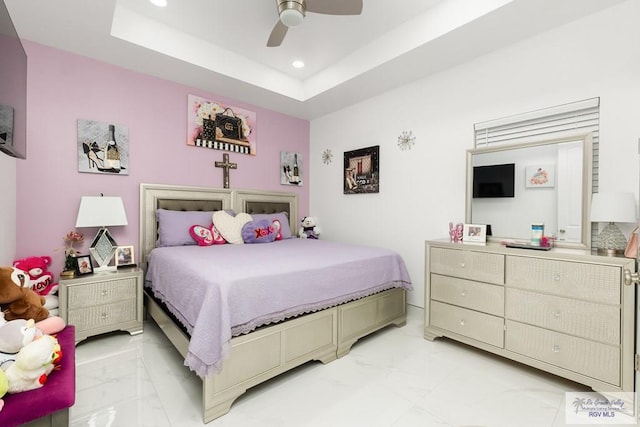 bedroom featuring a raised ceiling and ceiling fan