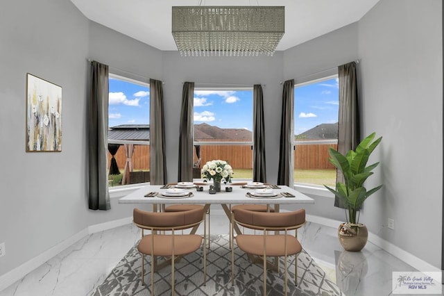 dining area with a mountain view and a notable chandelier