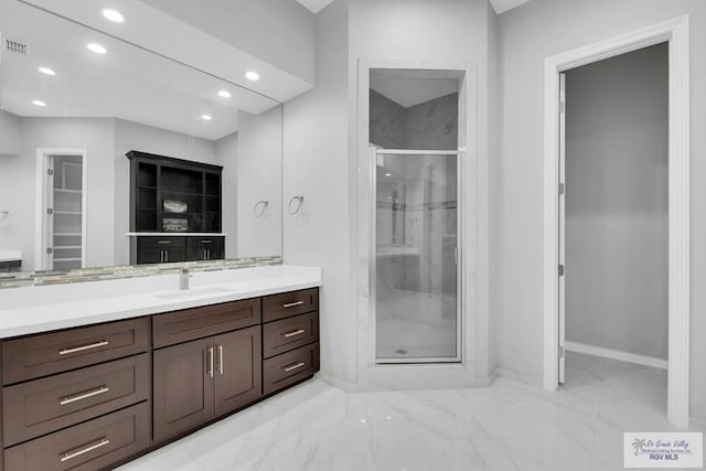 bathroom with vanity and a shower with shower door