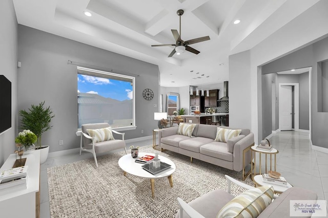 living room featuring ceiling fan and coffered ceiling