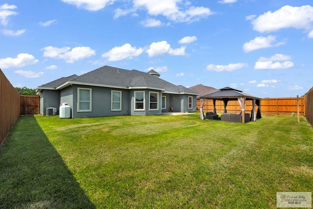 back of house with a gazebo, a lawn, and central AC