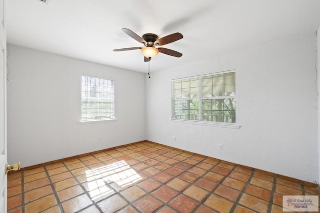 spare room featuring a ceiling fan