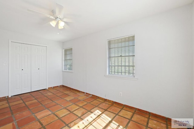 unfurnished bedroom with a closet and ceiling fan