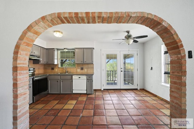 kitchen featuring a sink, stainless steel electric range, white dishwasher, and gray cabinetry