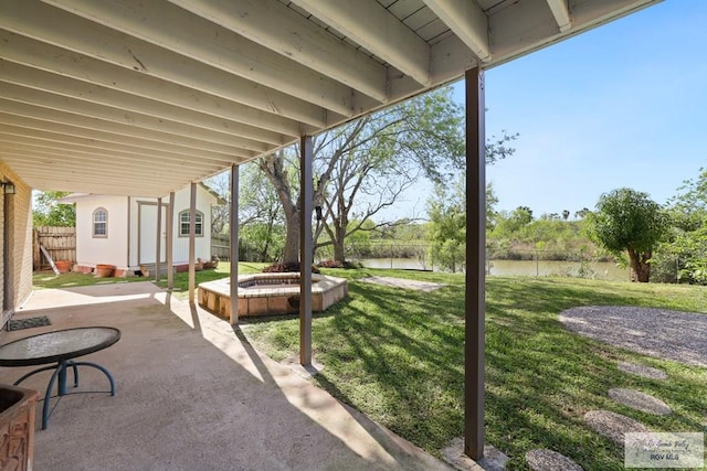 view of patio featuring an outdoor structure and fence