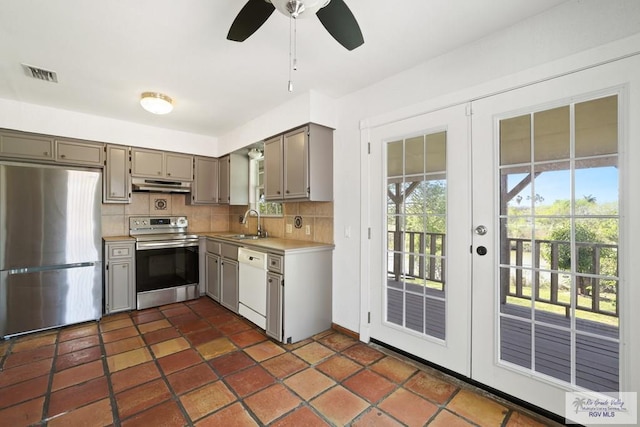 kitchen with under cabinet range hood, visible vents, gray cabinets, and stainless steel appliances