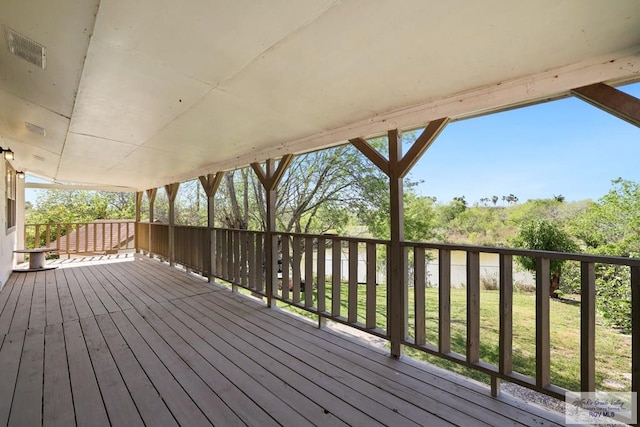 wooden deck with a lawn