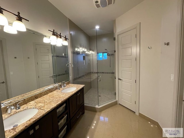 bathroom featuring vanity and an enclosed shower