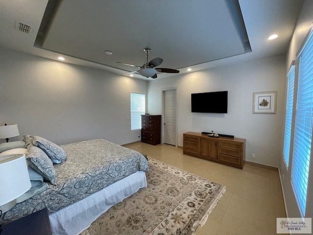 bedroom with ceiling fan and light tile patterned floors