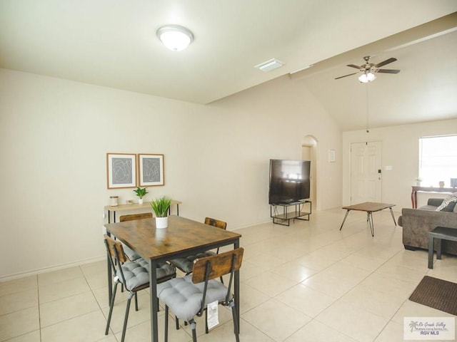 dining area featuring ceiling fan, light tile patterned floors, and lofted ceiling