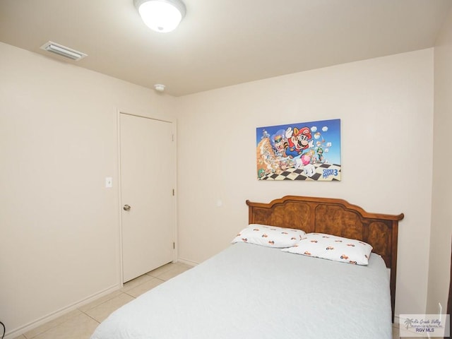 bedroom featuring light tile patterned flooring