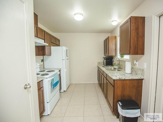 kitchen with light tile patterned flooring, electric range, light stone counters, and sink