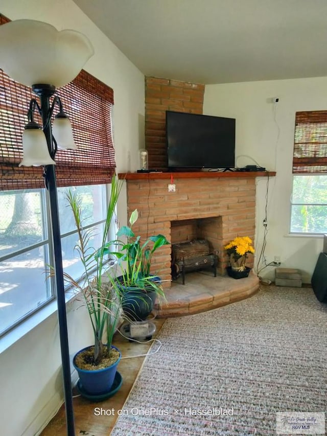 living area featuring a brick fireplace