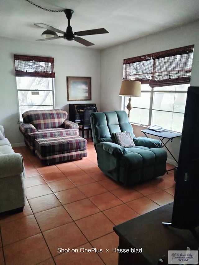 tiled living room with a ceiling fan