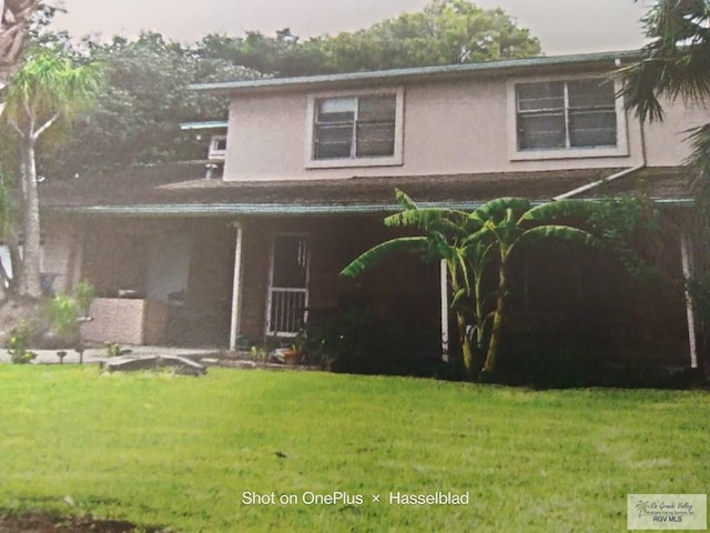 view of front of property featuring a front yard and stucco siding