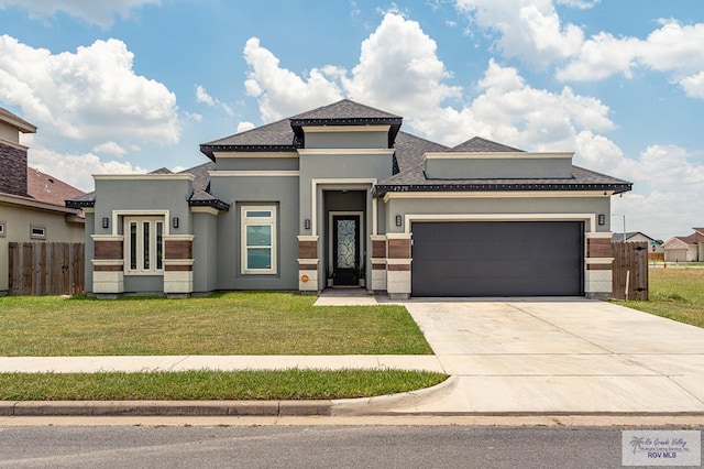 view of front facade featuring a garage and a front lawn