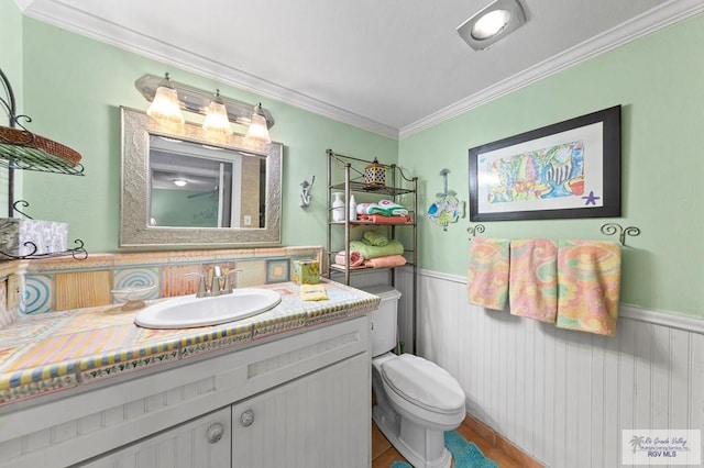 bathroom with vanity, toilet, ornamental molding, and backsplash