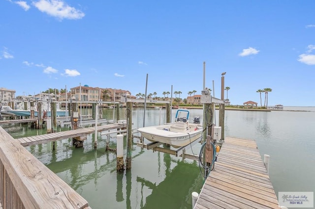 6201 Padre Blvd Unit 106, South Padre Island, TX 78597 - dock area featuring boat lift and a water view