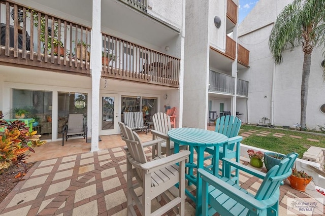 6201 Padre Blvd Unit 106, South Padre Island, TX 78597 - view of patio / terrace featuring outdoor dining area and a balcony