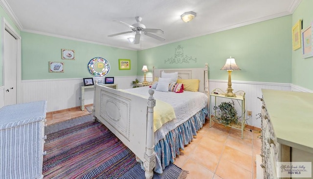 bedroom featuring ceiling fan, light tile patterned flooring, and ornamental molding