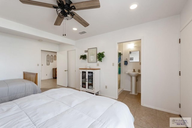 bedroom with light tile patterned floors, recessed lighting, visible vents, a sink, and baseboards