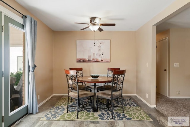 dining room with baseboards and a ceiling fan