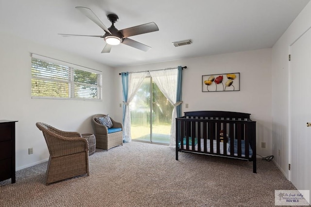 carpeted bedroom featuring a ceiling fan, access to exterior, visible vents, and baseboards