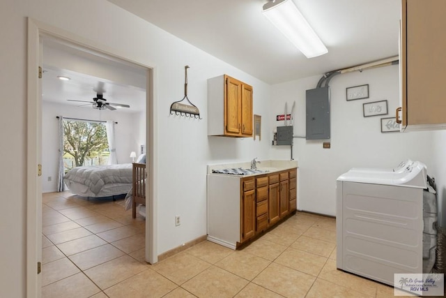 laundry area with light tile patterned floors, cabinet space, electric panel, and washer and dryer