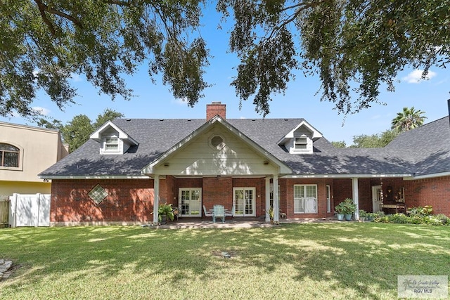 view of front of house with a front yard and a patio