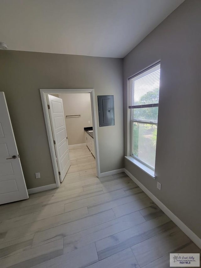 interior space with light wood-type flooring and electric panel