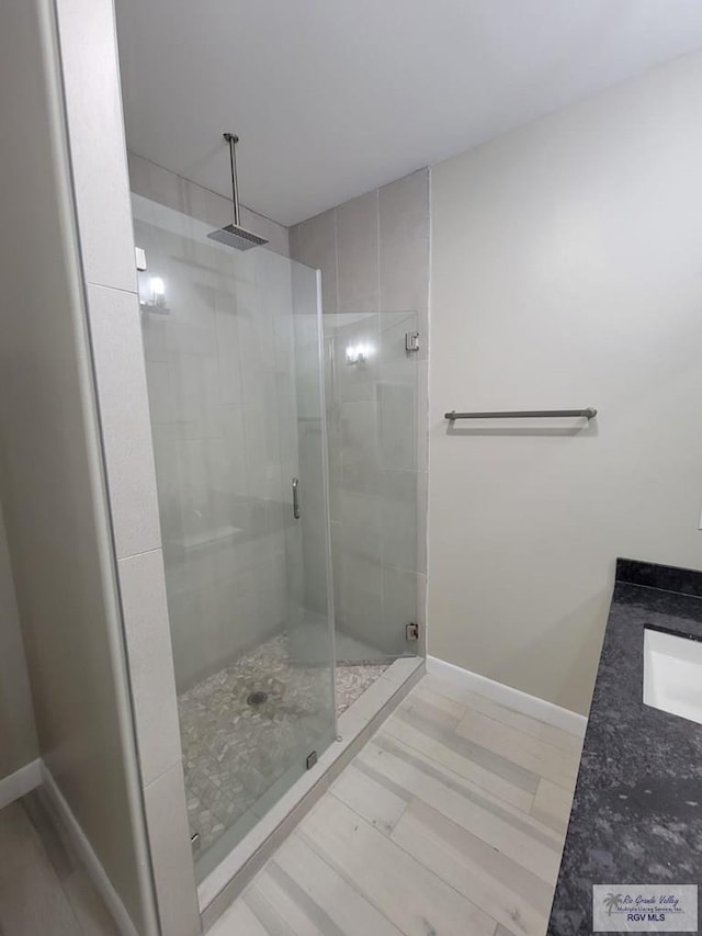 bathroom featuring vanity and a shower with door