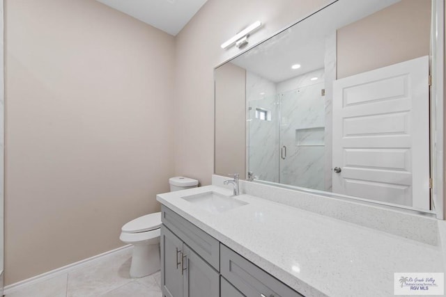 full bathroom with a marble finish shower, tile patterned flooring, baseboards, toilet, and vanity