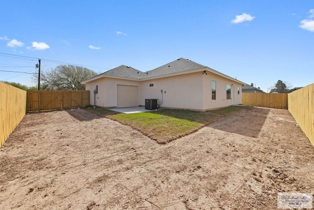 back of property featuring central air condition unit, a fenced backyard, stucco siding, and a patio area