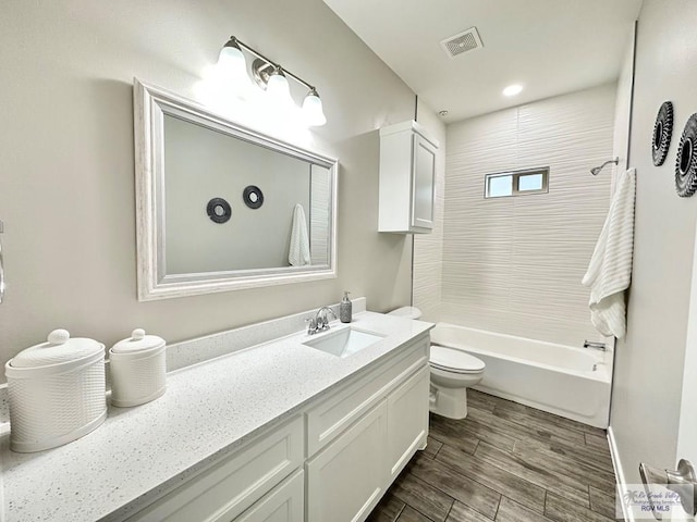 1505 Shavano Dr, Edinburg, TX 78541 - full bathroom with toilet, vanity, wood finished floors, and shower / bathtub combination