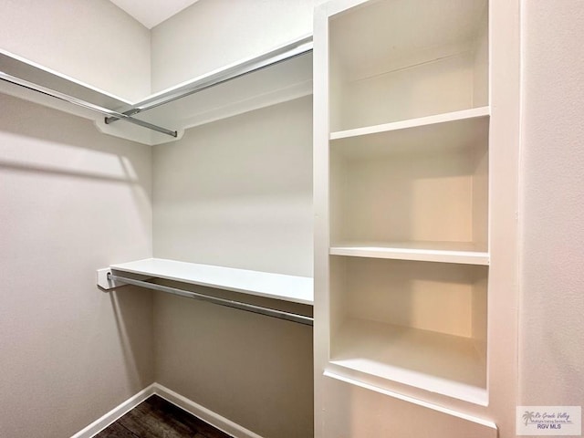 1505 Shavano Dr, Edinburg, TX 78541 - walk in closet with dark wood-type flooring