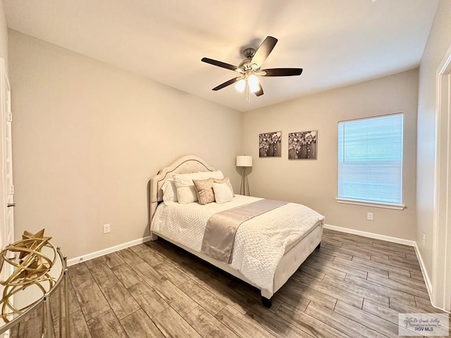 1505 Shavano Dr, Edinburg, TX 78541 - bedroom featuring wood finished floors, baseboards, and a ceiling fan