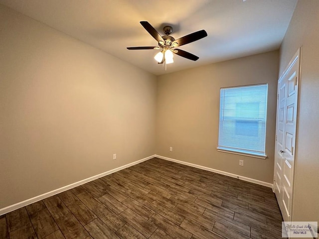 1505 Shavano Dr, Edinburg, TX 78541 - empty room featuring dark wood-style flooring, a ceiling fan, and baseboards